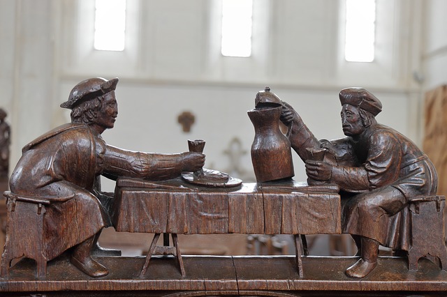 A statue of monks sharing wine